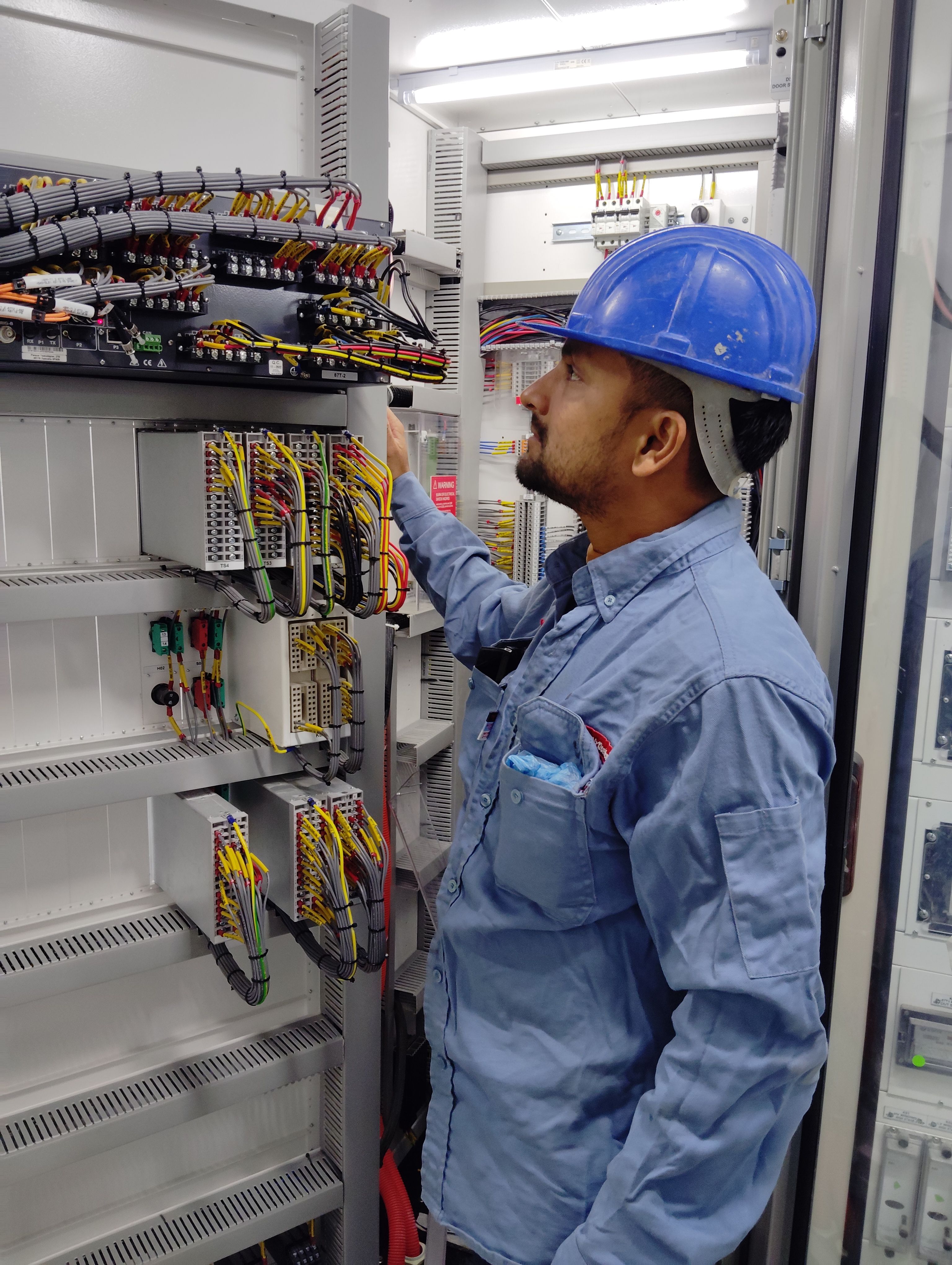 Electrician repairing electrical outlet and wiring
